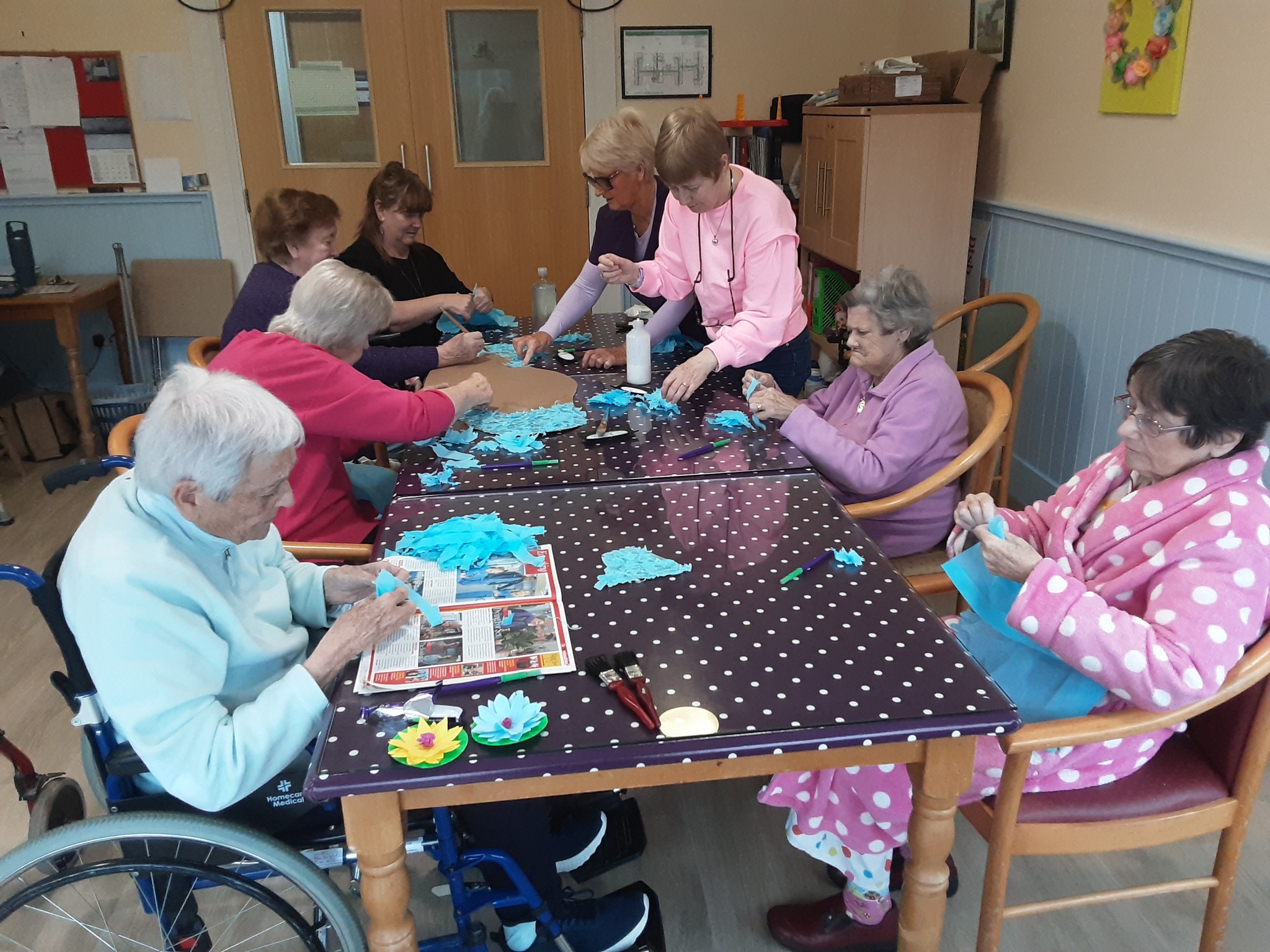 residents of the nursing home enjoying an art therapy session
